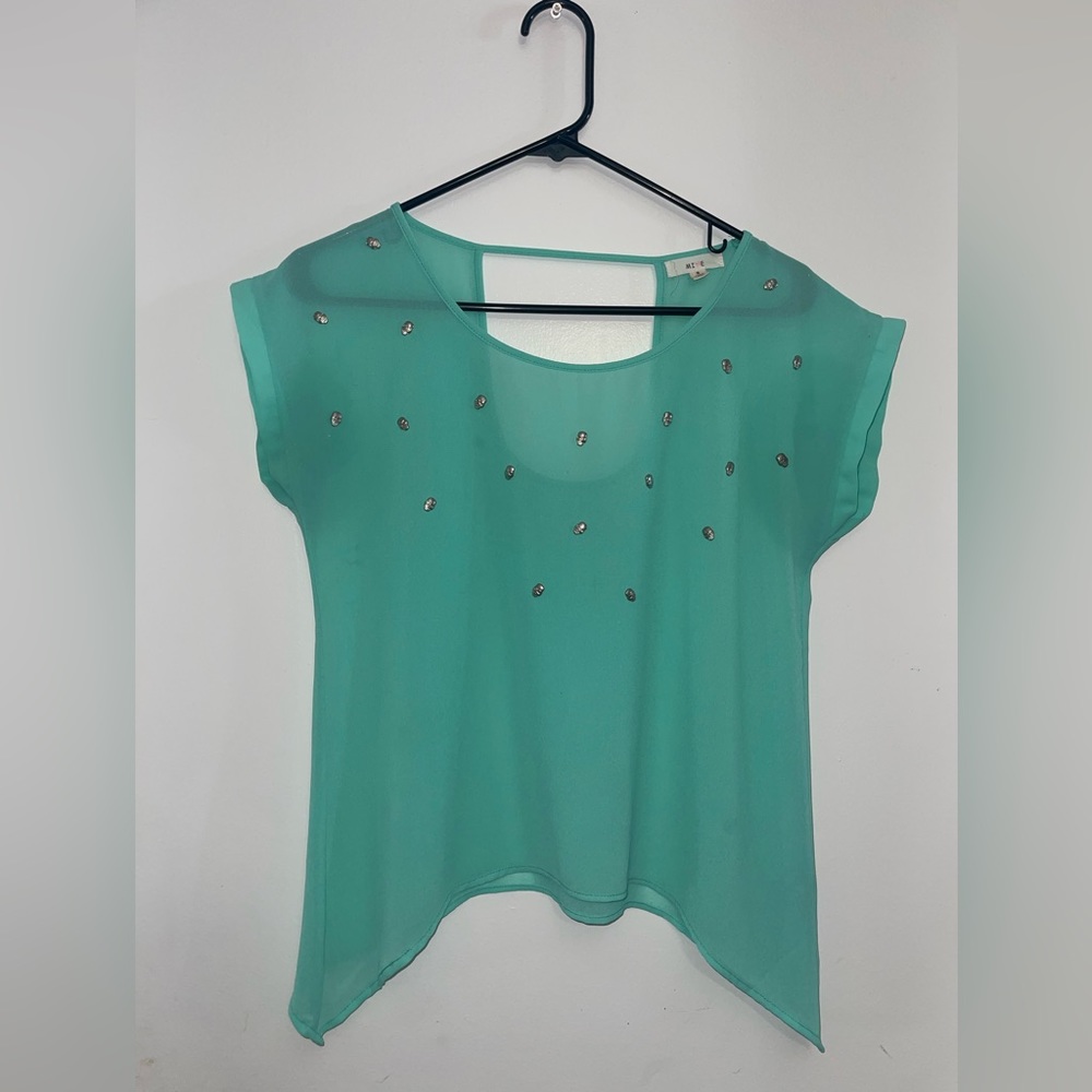 Minty green size small with little metal skulls on the shirt.